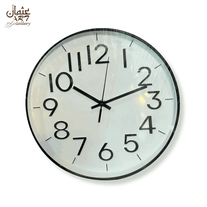 White quartz wall clock with round white face, large black Arabic numerals, black hands, and black outer frame