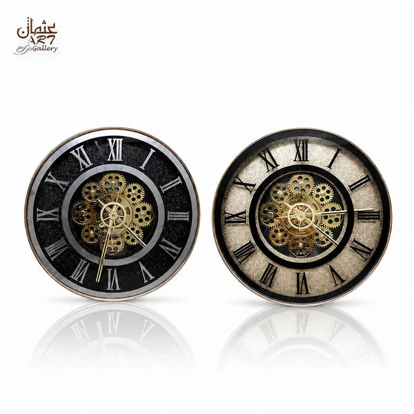 Two black and gold Roman numeral decorative clocks with gear-style centres